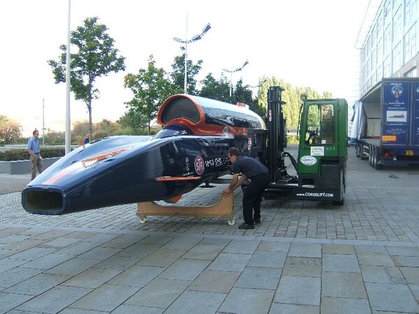 Having been safley unloaded and spun thro' 360 degrees by Ability Handling Ltd's C4000 multi-directional Combilft; the 42 foot 1.1 ton scale model of the Bloodhound SSC 1000MPH Car is carefully placed onto purpose built cradles ready for exhibition at Doncaster College.