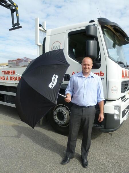 David tries out his new Doosan Golfing Umbrella after winning the prize tickets of a trip to the 2011 Open Championship.