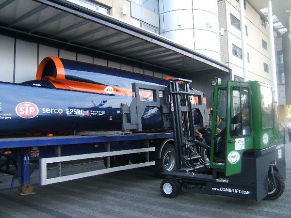 Combilift C4000 with 4m spreader frame unloads 42 foot long Bloohound Super Sonic Car at Doncaster College.